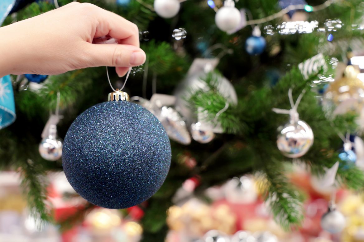 Christmas tree with lights and ornaments in the corner